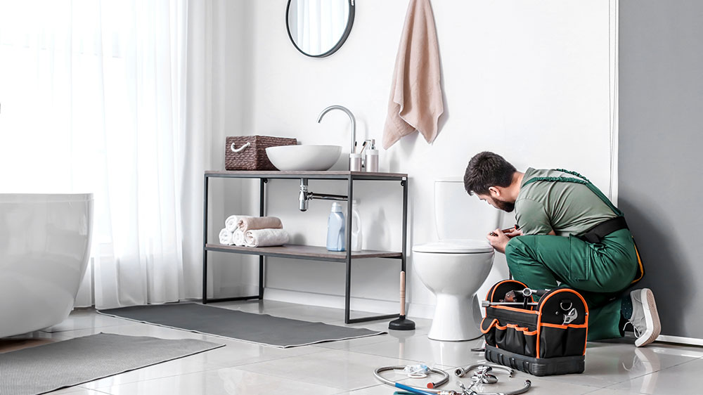 Bathroom Fitter Installing toilet in new bathroom