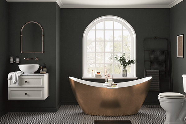 Bathroom with dark grey walls with a gold bathtub in front of a large feature window.