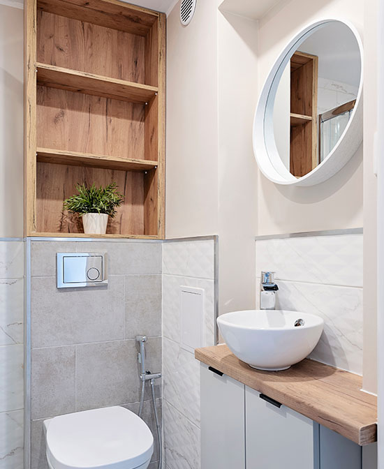 Embedded storage above a toilet in a small bathroom to show use of space