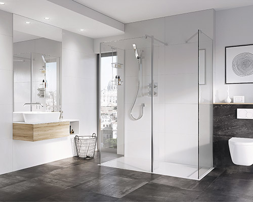 Bathroom with a large walk in show with clear glass panels