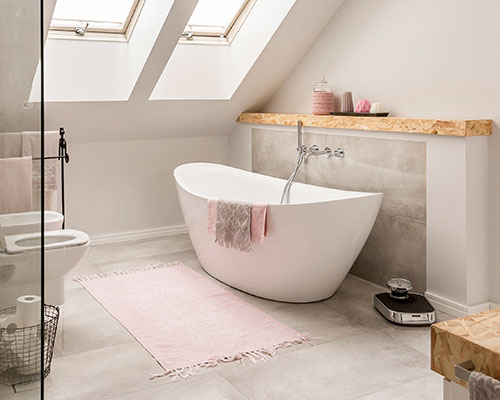 Natural looking bathroom with free standing bath tub and shower unit, accented with cork style counters